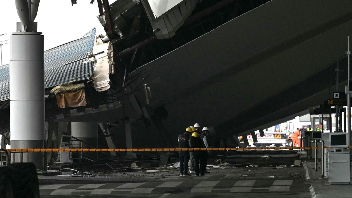 Authorities seen at the site of the collapsed terminal roof of New Delhi's Indira Gandhi International Airport after heavy rains in New Delhi on June 28. — Photo: AFP
