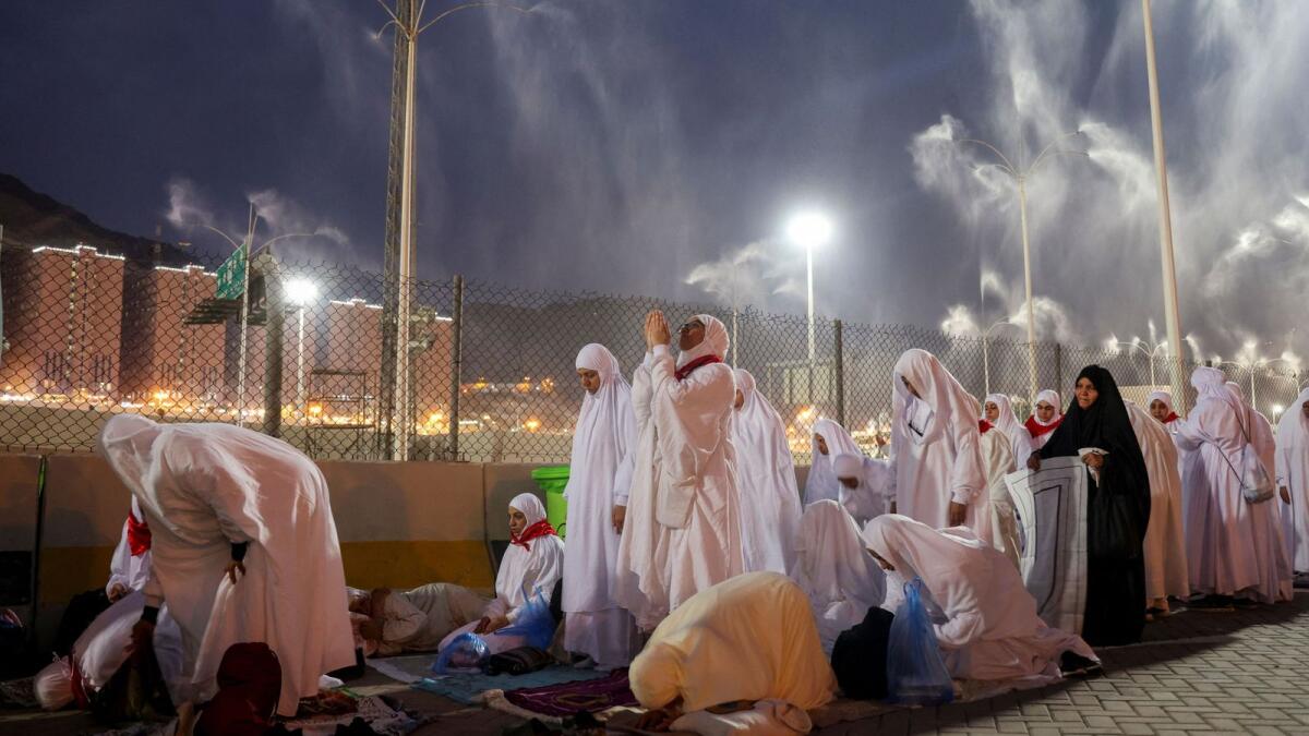 Muslim pilgrims pray as sprinklers spray water to cool them down amid extremely hot weather, during the annual Haj pilgrimage in Saudi Arabia. Photo: Reuters file