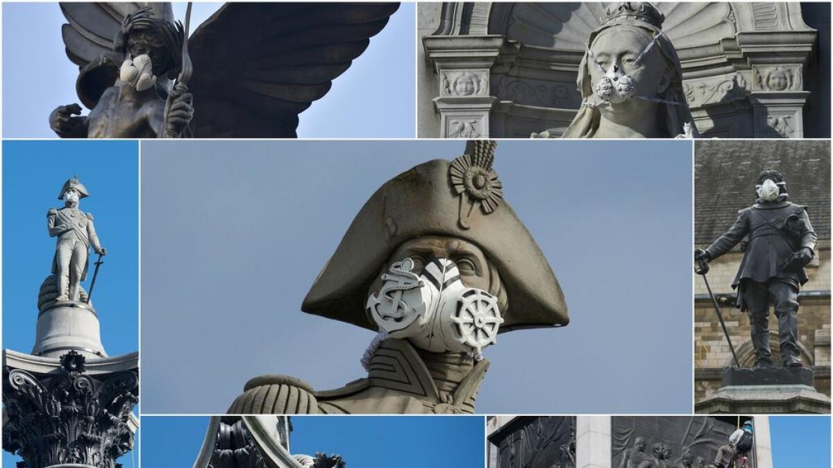 Anti-pollution activists cover London statues with masks