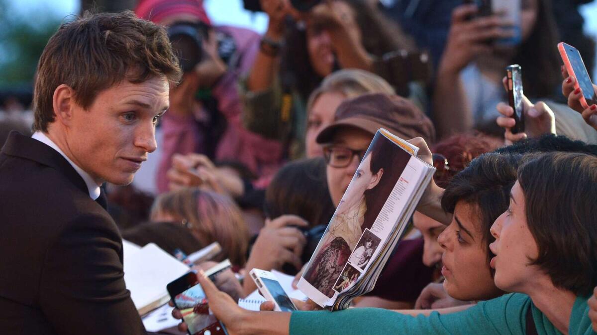 Eddie Redmayne signs autographs before the screening of the movie The Danish Girl at the Venice Film Festival.