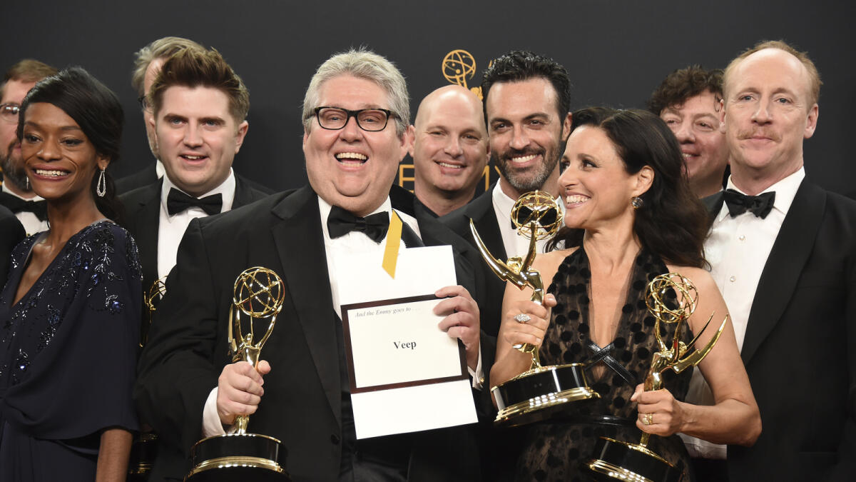 David Mandel, center, Julia Louis-Dreyfus, foreground right, and the cast and crew from 'Veep' winners of the award for outstanding comedy series pose in the press room at the 68th Primetime Emmy Awards on Sunday, Sept. 18, 2016, at the Microsoft Theater in Los Angeles. AP