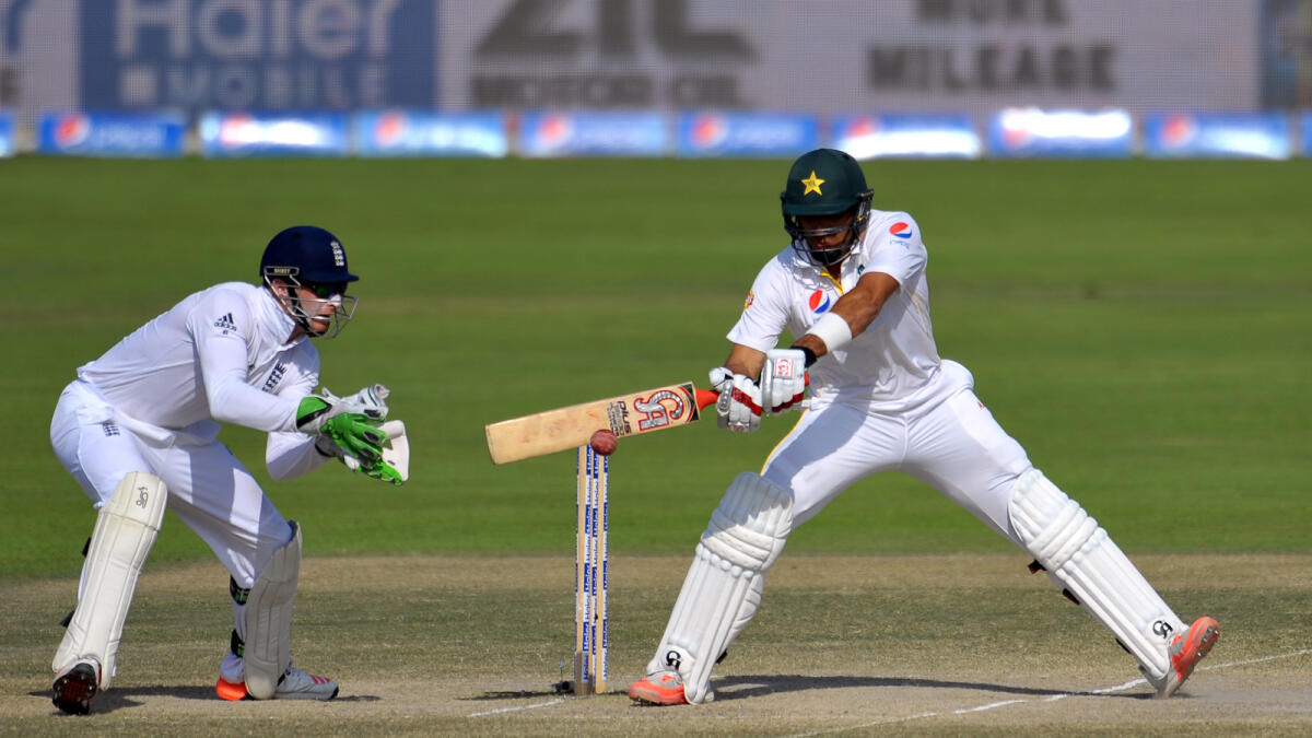Pakistan captain Misbah-ul-Haq plays a shot as England wicketkeeper Jos Buttler looks on during the fifth day of the first Test in Abu Dhabi on Saturday. 
