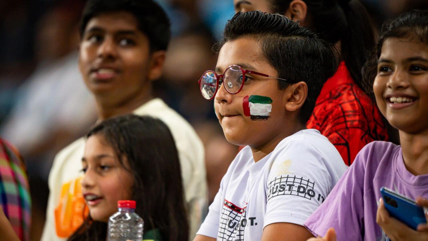 A kid with UAE flag paint watches the action against New Zealand during the second T20I match at Dubai International Stadium on Saturday