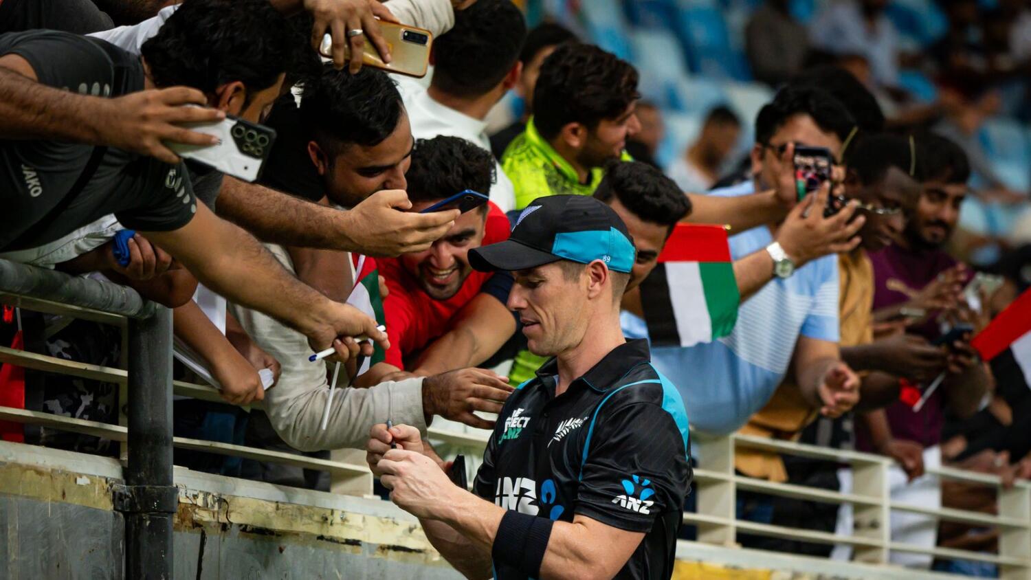 New Zealand's Cole Edward McConchie signs autograph between overs during the second T20I against UAE at Dubai International Stadium on Saturday