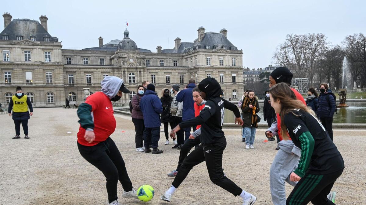 Women calling themselves the 'Hijabers' play football in the Luxembourg garden facing the French Senate in Paris in 2022 as a protest after senators voted in favour of a ban of the wearing of religious symbols during events and competitions organised by sports federations. — Photo: AFP file