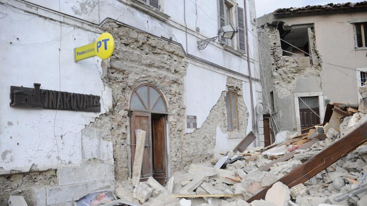 A post office is engulfed by rubbles in Arcuata del Tronto, central Italy. AP