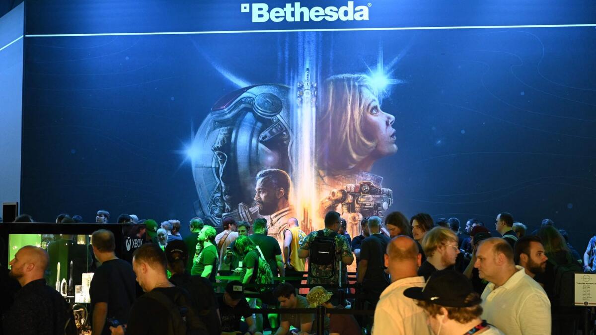 Visitors wait for a film of the Starfield game at the Xbox booth at the Gamescom video game fair in Cologne, Germany, last month. — AFP File