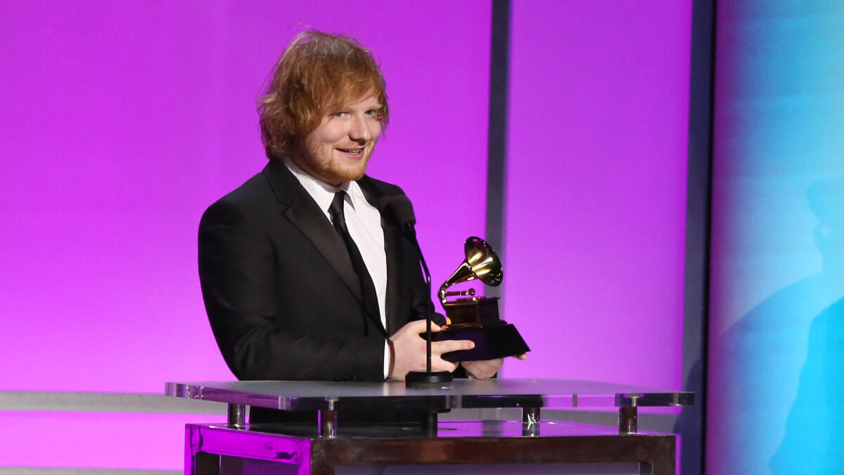 Ed Sheeran accepts the award for best pop solo performance for 'Thinking Out Loud' at the 58th annual Grammy Awards on Monday, Feb. 15, 2016, in Los Angeles.