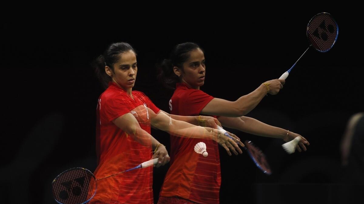 Saina Nehwal of India serves during women's singles match. Picture taken with multiple exposure.
