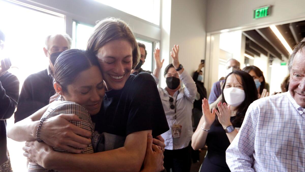 Los Angeles Times photographer Christina House, left, is hugged by former LA Times videographer Claire Collins after House won the Pulitzer Prize for Feature Photography at the Los Angeles Times in El Segundo, California on Monday.  — AP