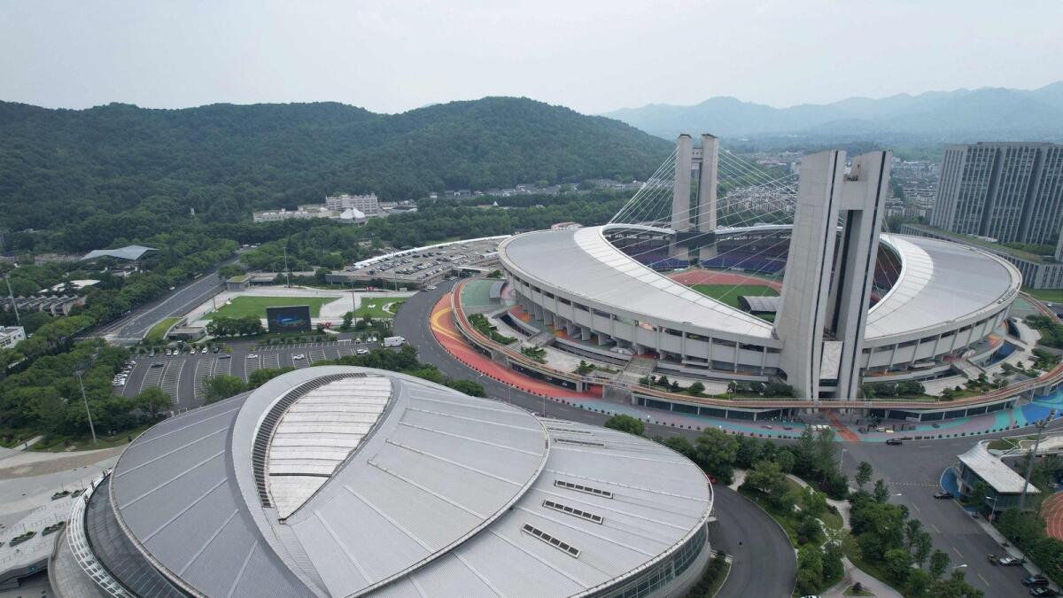 This Yellow Dragon Sports Center Stadium (back) and Gymnasium, venues of the 19th Asian Games, in Hangzhou in China's eastern Zhejiang province. - AFP