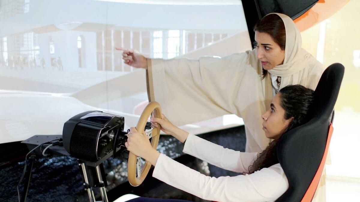 A driving instructor teaches trainee Maria Al Faraj during a driving lesson on a 3D screen in Dhahran, Saudi Arabia. — Reuters