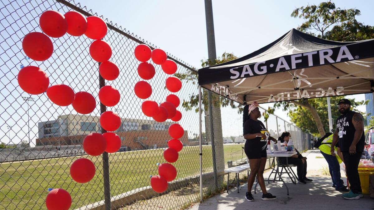 Balloons are arranged into a '99' to commemorate the 99th day of the SAG-AFTRA strike on October 20. — AP