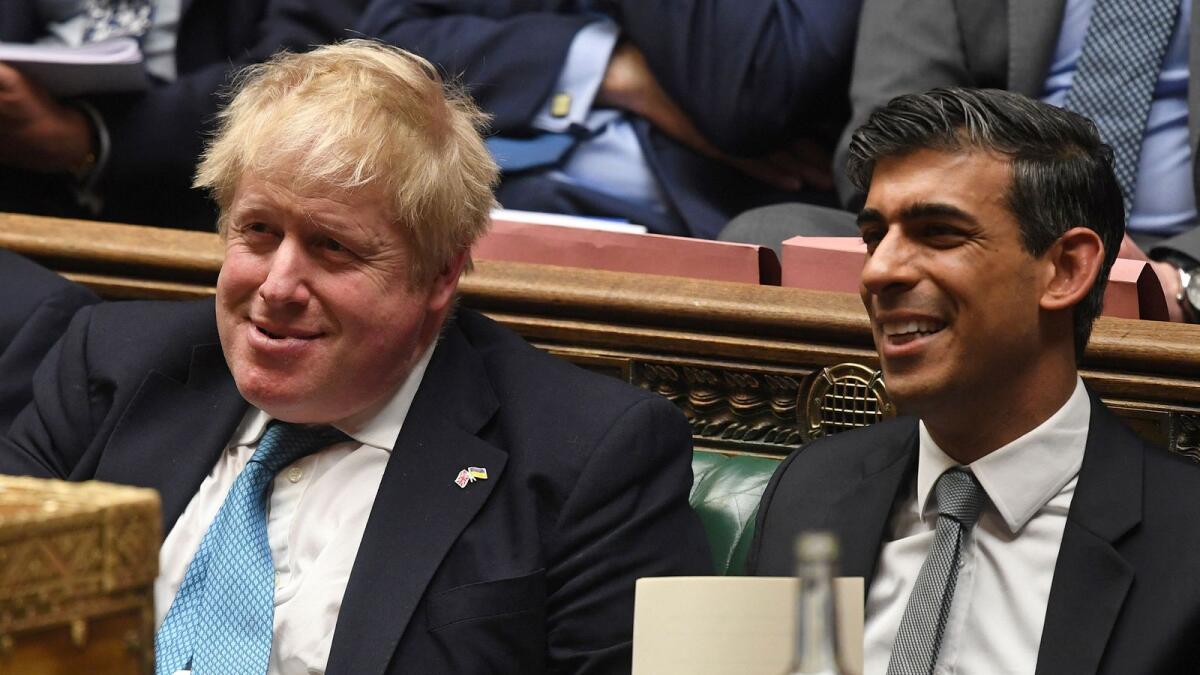 Boris Johnson (L) and Rishi Sunak at the House of Commons, in London. — AFP file