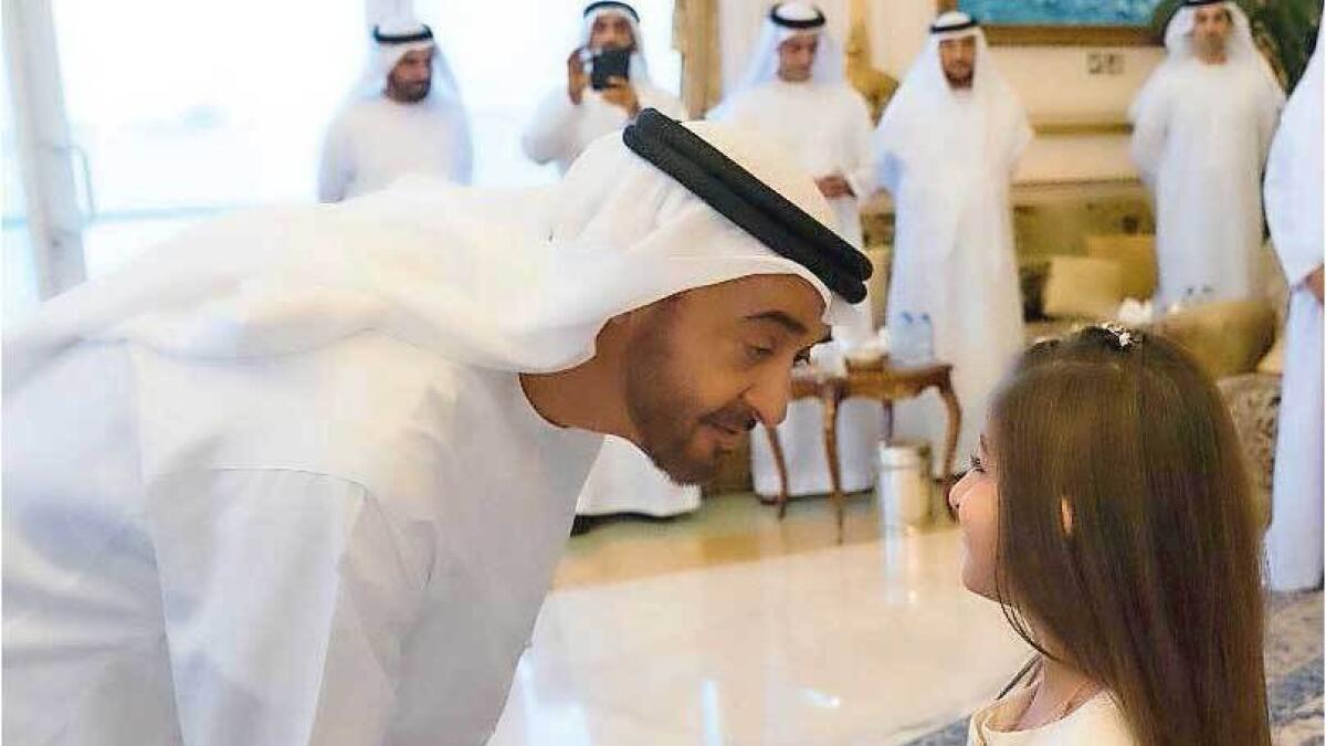His Highness Sheikh Mohamed bin Zayed Al Nahyan, Crown Prince of Abu Dhabi and Deputy Supreme Commander of the UAE Armed Forces, greets Rouda, daughter of a martyr. — Wam file photo