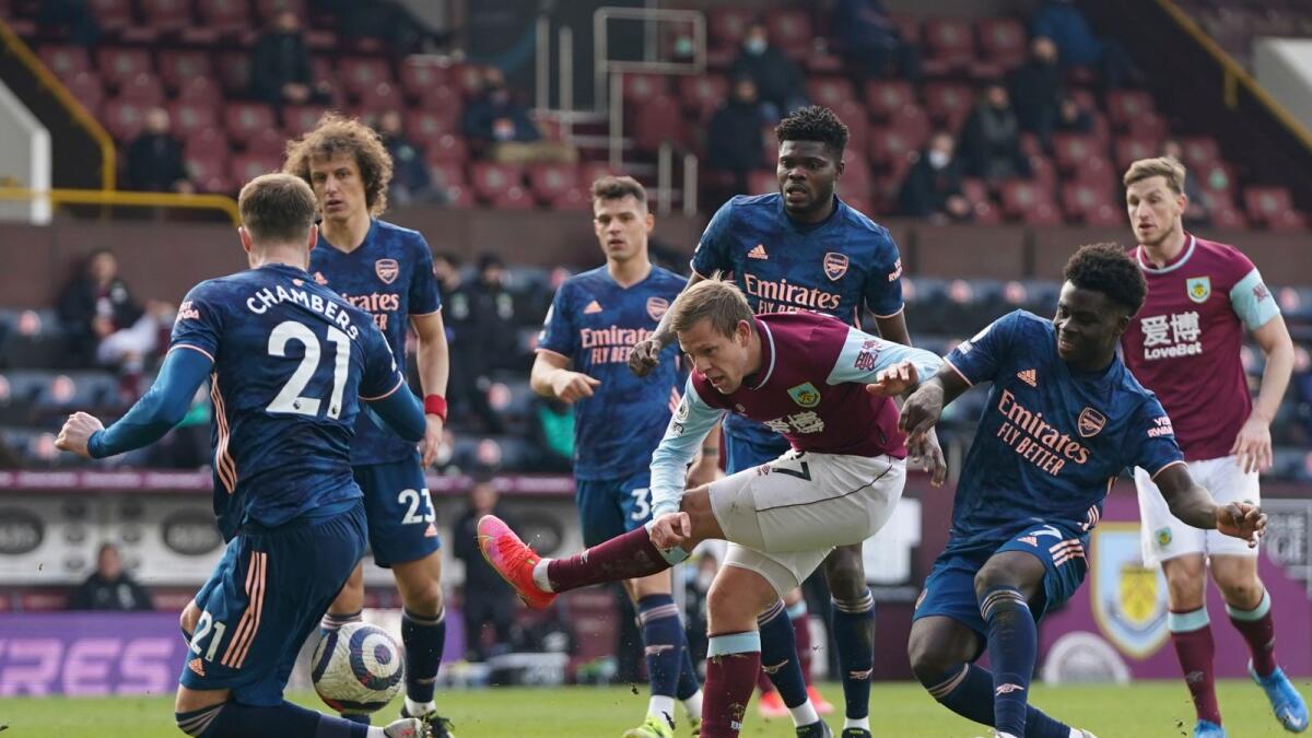 Burnley's Johann Berg Gudmundsson (centre) kicks the ball during the English Premier League match against Arsenal at Turf Moor stadium. — AP