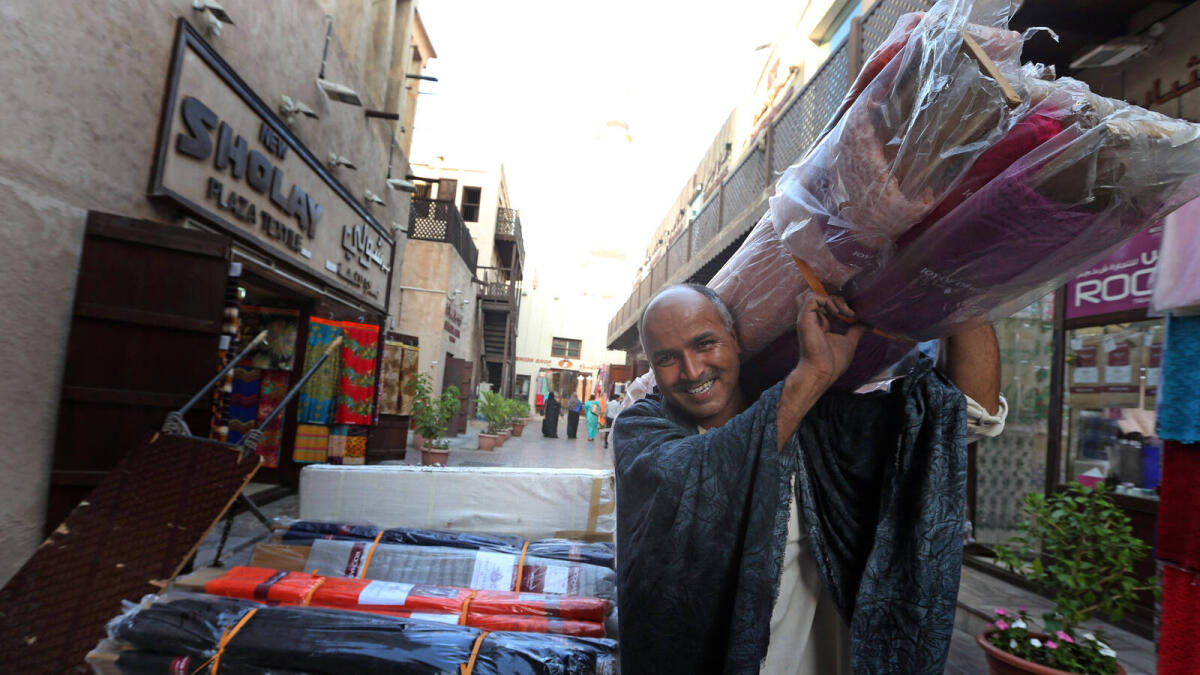 HAPPY TO SERVE YOU ... Mohammad Azam, 42, from Pakistan has been working at the souk for two decades with the same smile.