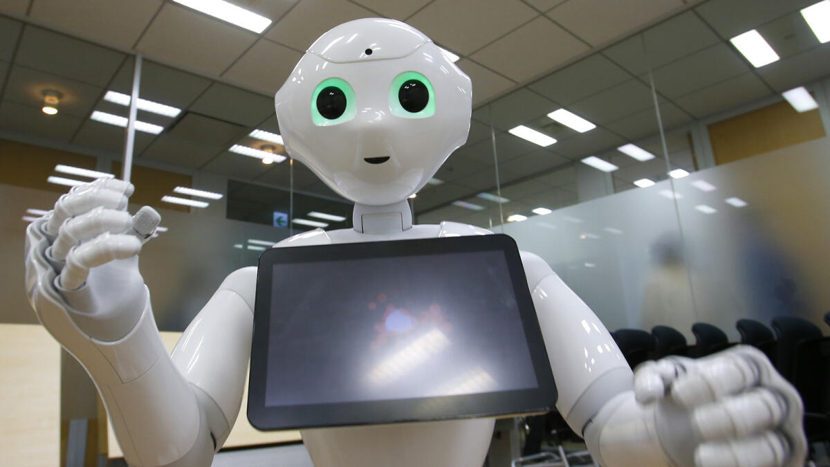 Robot Pepper performs during an interview at the SoftBank Corp.’s headquarters in Tokyo. — AP