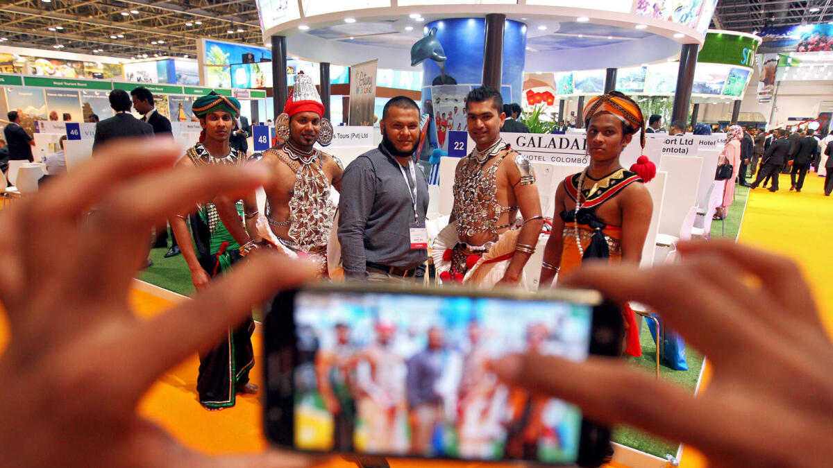 Visitors taking photos at the Sri Lanka pavilion during Arabian Travel Market at Dubai World Trade Centre on April 25, 2016.