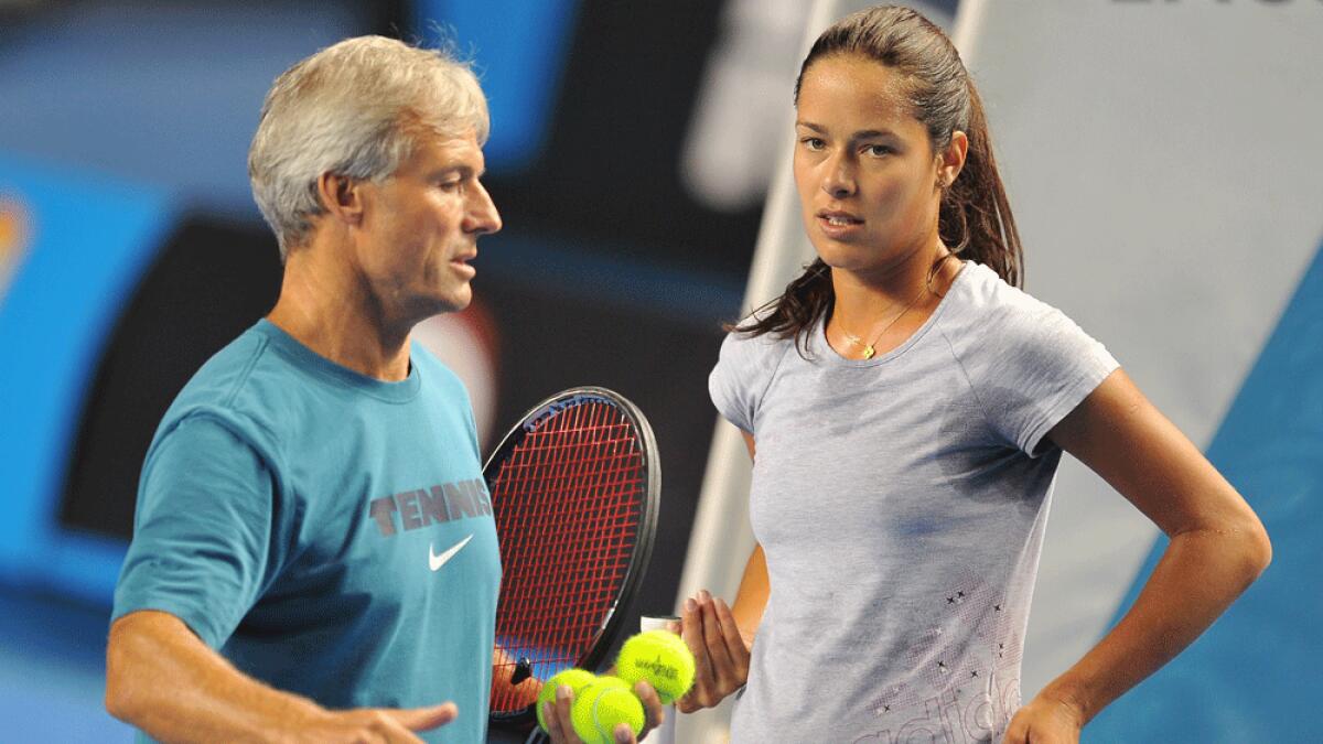 Ana Ivanovic listens to her coach Nigel Sears during a practice session for the 2012 Australian Open tennis tournament in Melbourne.