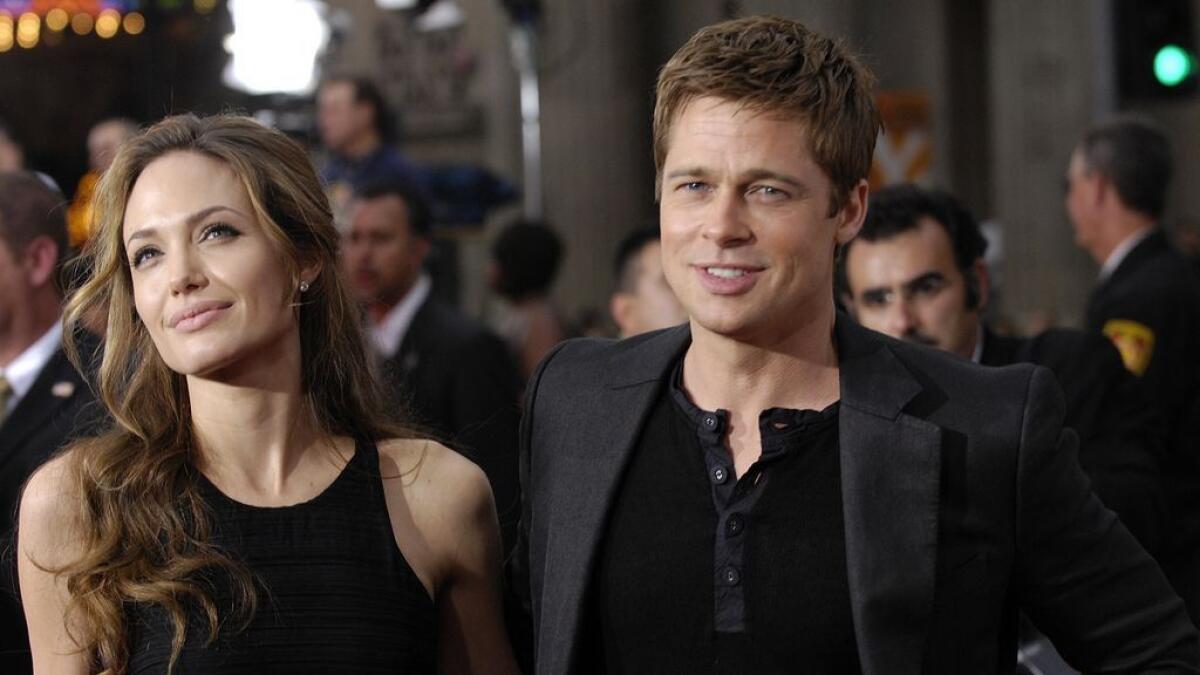 Brad Pitt, right, arrives with Angelina Jolie. 