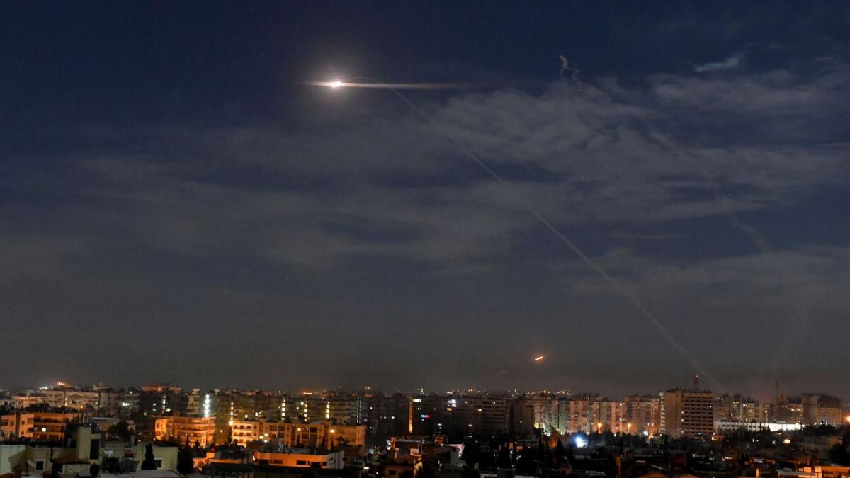 File - In this photo released by the Syrian official news agency SANA, shows missiles flying into the sky near international airport, in Damascus, Syria, Monday, Jan. 21, 2019 (SANA via AP, File)
