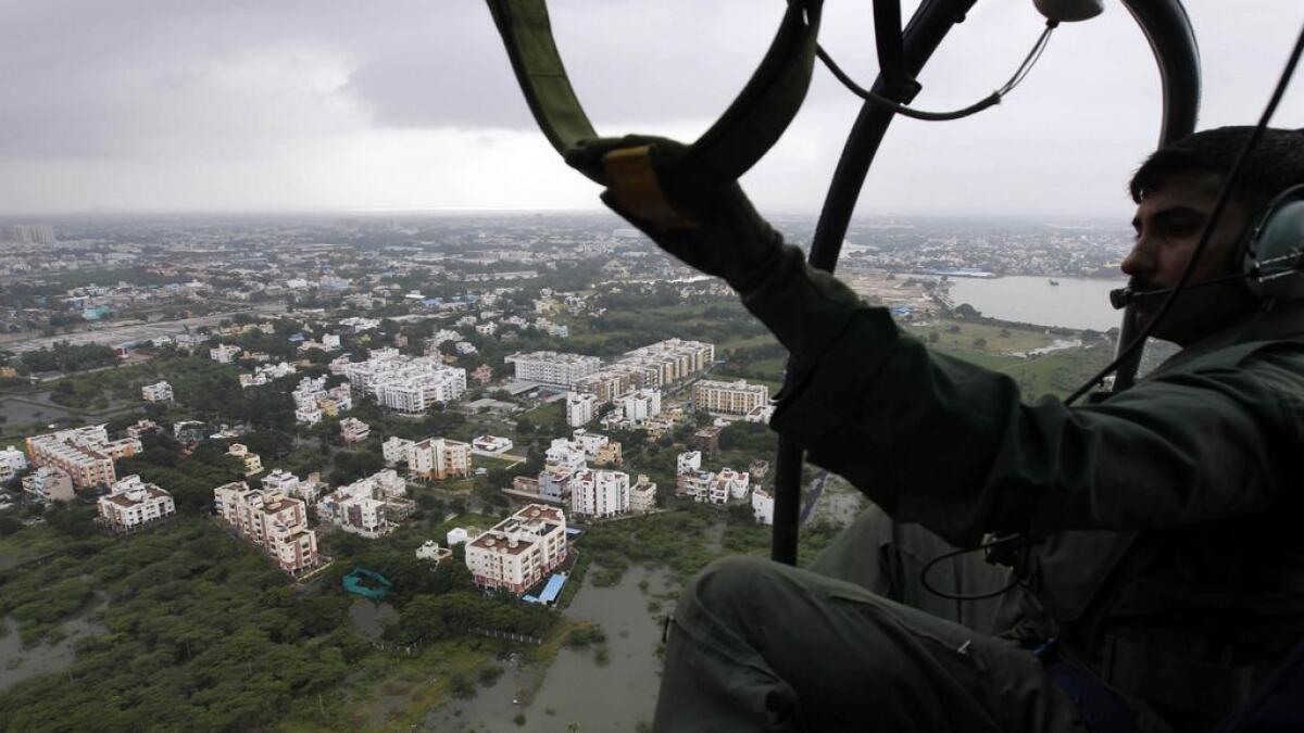 A coastguard sailor surveys an area inundated by floodwaters in Chennai, India.