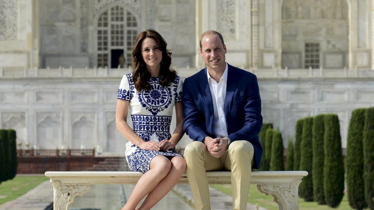 Britains Prince William and his wife Catherine, the Duchess of Cambridge, pose as they sit in front of the Taj Mahal in Agra, India. 