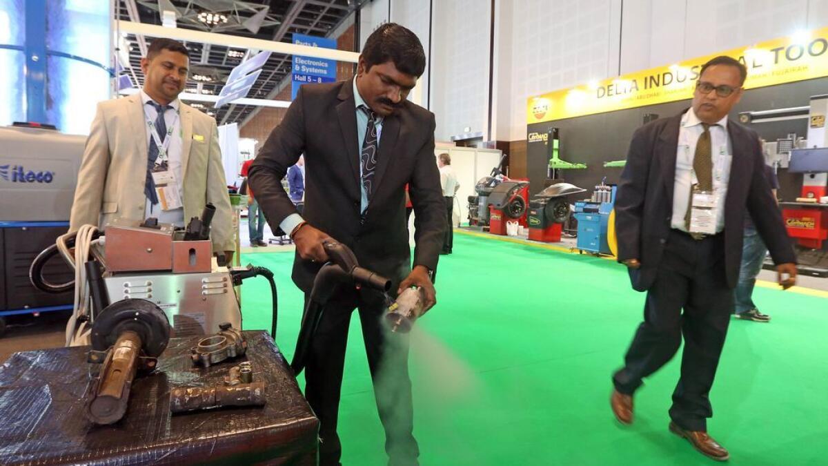 An executive tests a steam cleaner at the pavilion of Constromech UAE at Automechanika Dubai 2016 on Sunday.