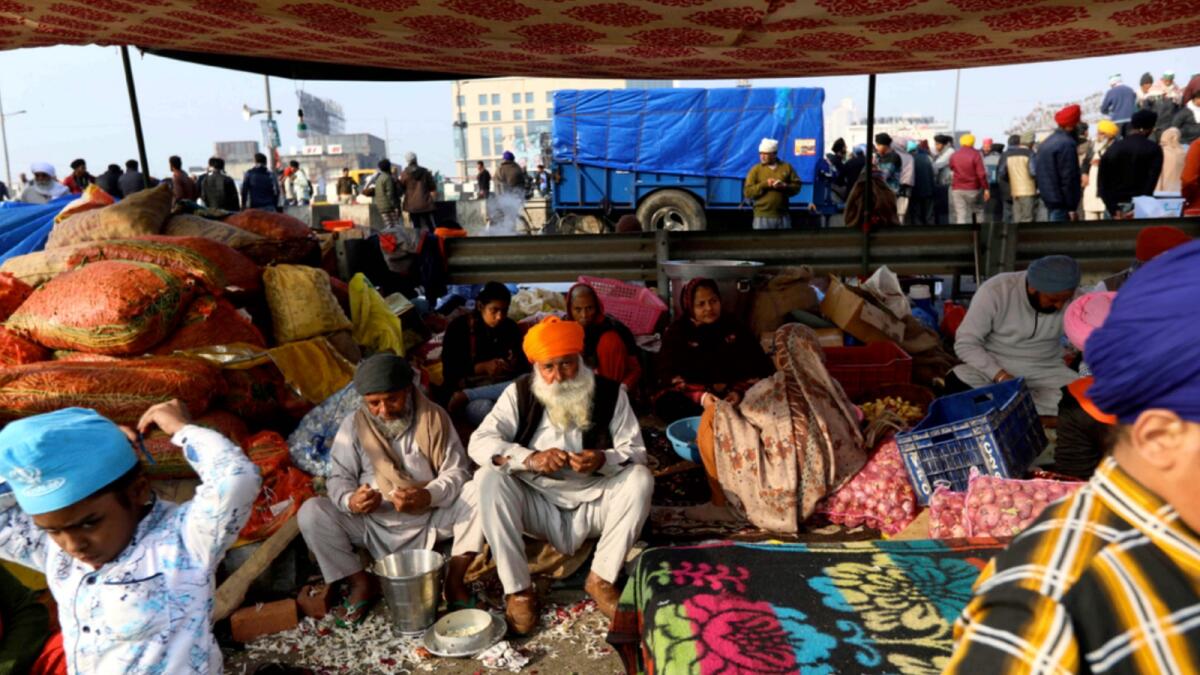 Family of an Indian farmer prepares food for fellow farmers as they block a highway in protest against new farm laws at the Delhi-Uttar Pradesh state border. — AP