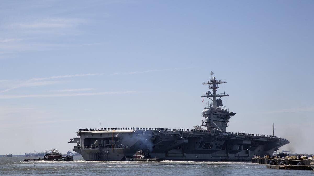 The USS Abraham Lincoln deploys from Naval Station Norfolk, in the vicinity of Norfolk, Va.- AP file photo