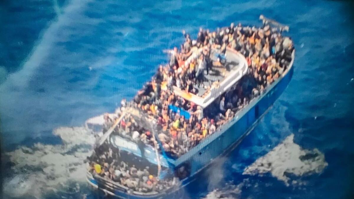 Scores of people on a battered fishing boat that later capsized and sank off southern Greece. — AP file