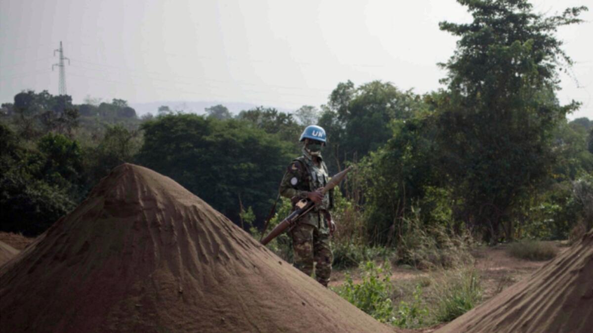 A peace-keeper from the Rwandan battalion of the United Nations Multidimensional Integrated Stabilization Mission in the Central African Republic (MINUSCA) stands behind piles of sand on the road to Damara, where skirmishes took place during the week. — AFP