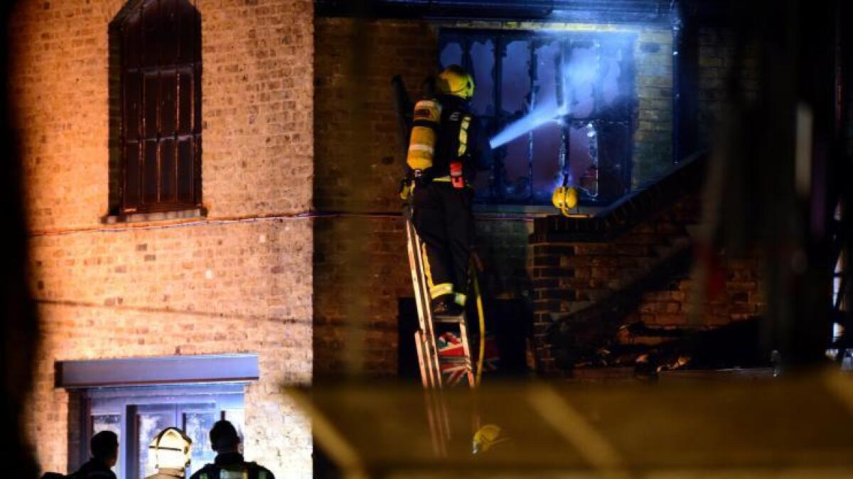 Firefighters stand near a fire at Camden Market in north London.