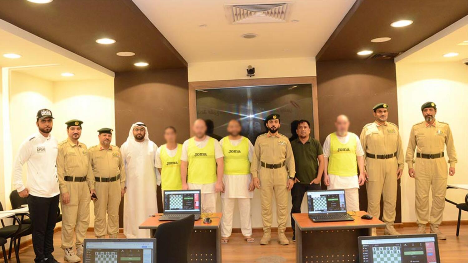 Dubai Police officers with inmates.