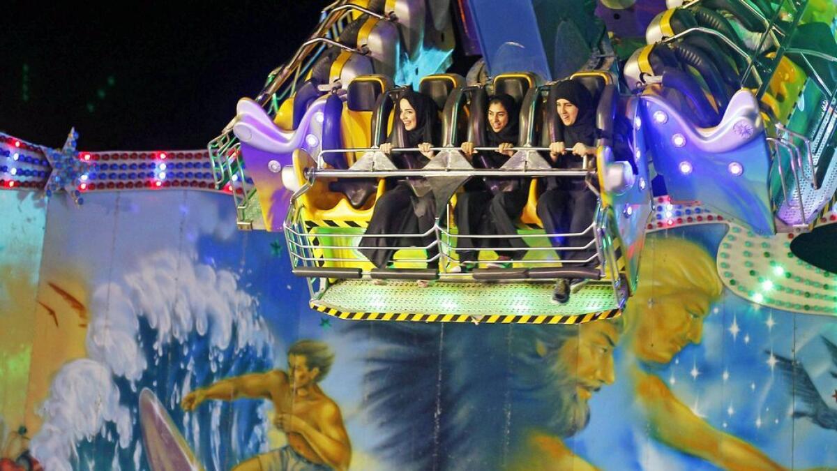 Ladies enjoy the ride on a twisted swing at the Global Village in Dubai.- Photo by M.Sajjad/Khaleej Times