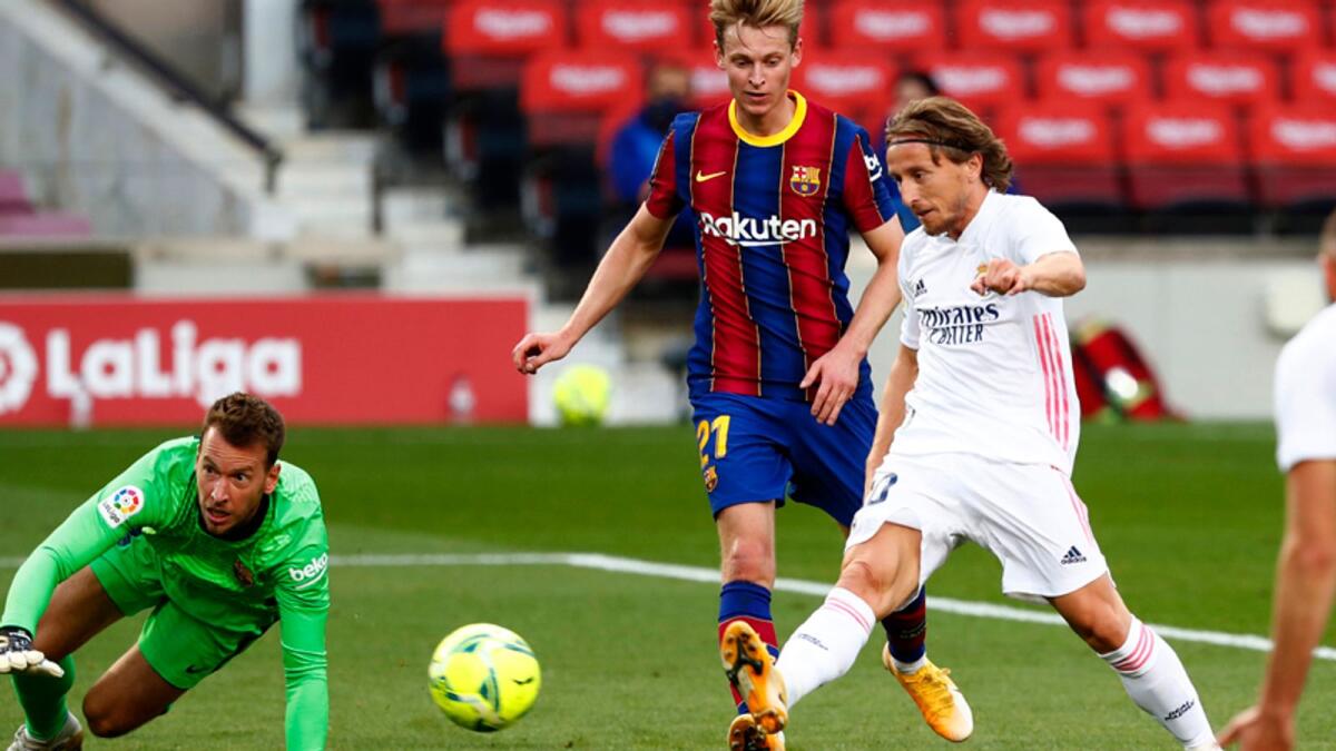Real Madrid's Luka Modric scores his side's third goal during the La Liga soccer match against Barcelona. — AP