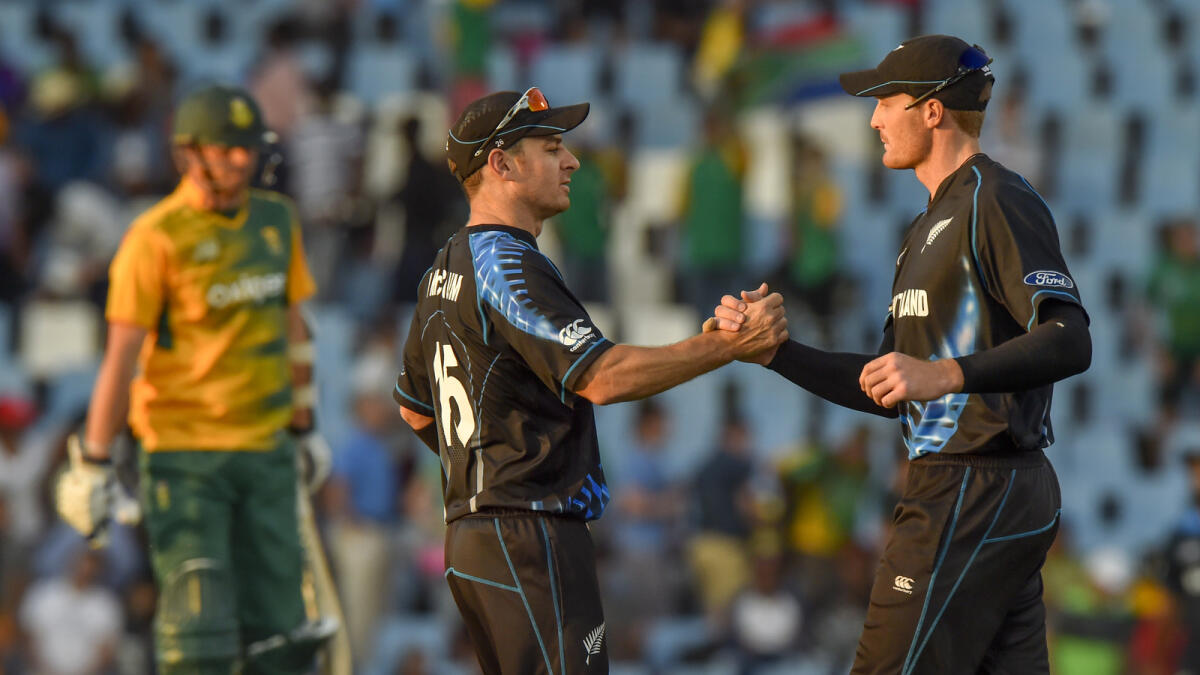 New Zealand’s Nathan McCullum celebrates with teammate Martin Guptill after winning the second T20I against South Africa. 