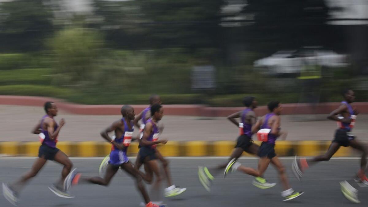 Participants run during the Delhi Half Marathon in New Delhi, India. 