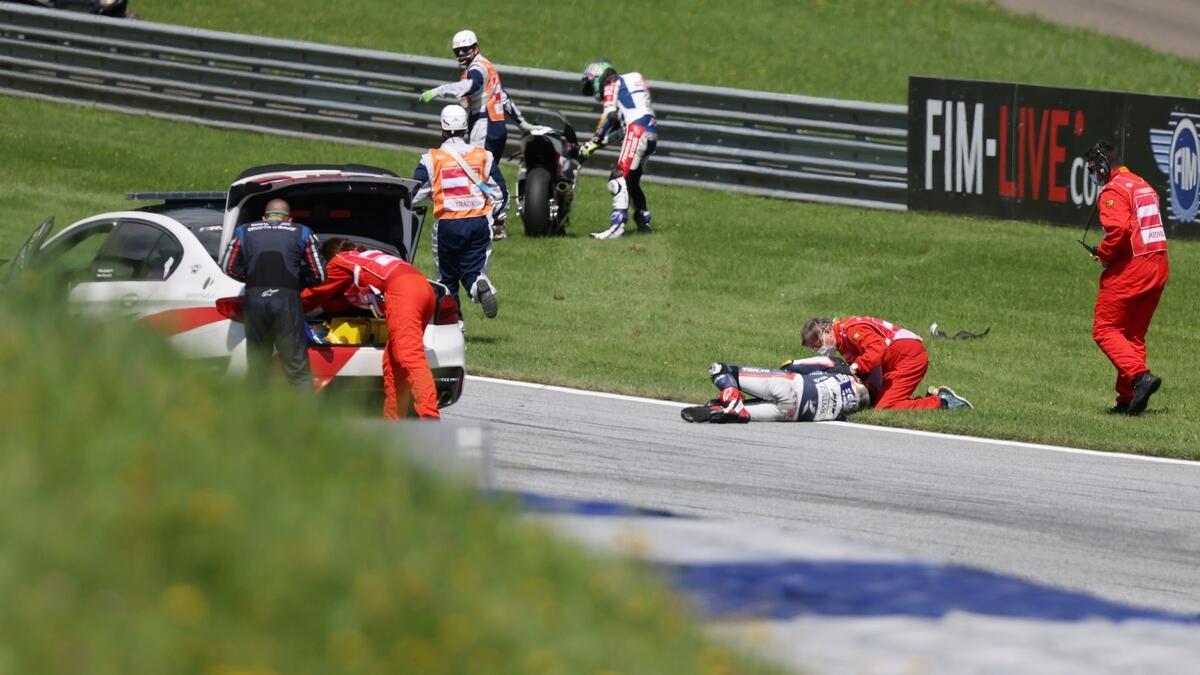 Openbank Aspar Team's Hafizh Syahrin receives medical attention after crashing during the Moto2 race