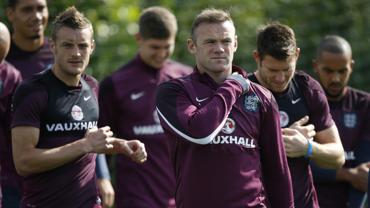 England’s Wayne Rooney with teammates during a practice session. 