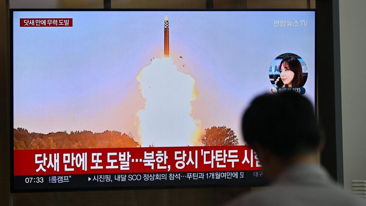 A man watches a television screen showing a news broadcast with file footage of a North Korean missile test, at a train station in Seoul on Monday. AFP