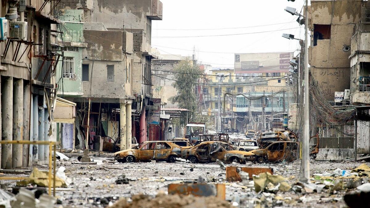 A completely destroyed street in Mosul with burnt cars and buildings after clashes between Iraqi forces and Daesh in March this year. —Photo by Reuters