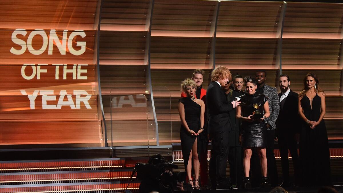 Ed Sheeran (3L) recieves the award for the Song of the Year, Thinking Out Loud during the 58th Annual Grammy music Awards in Los Angeles February 15, 2016.