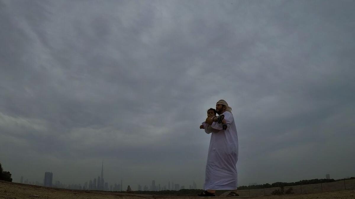 Father and kids enjoys Cool and shady weather in Dubai.