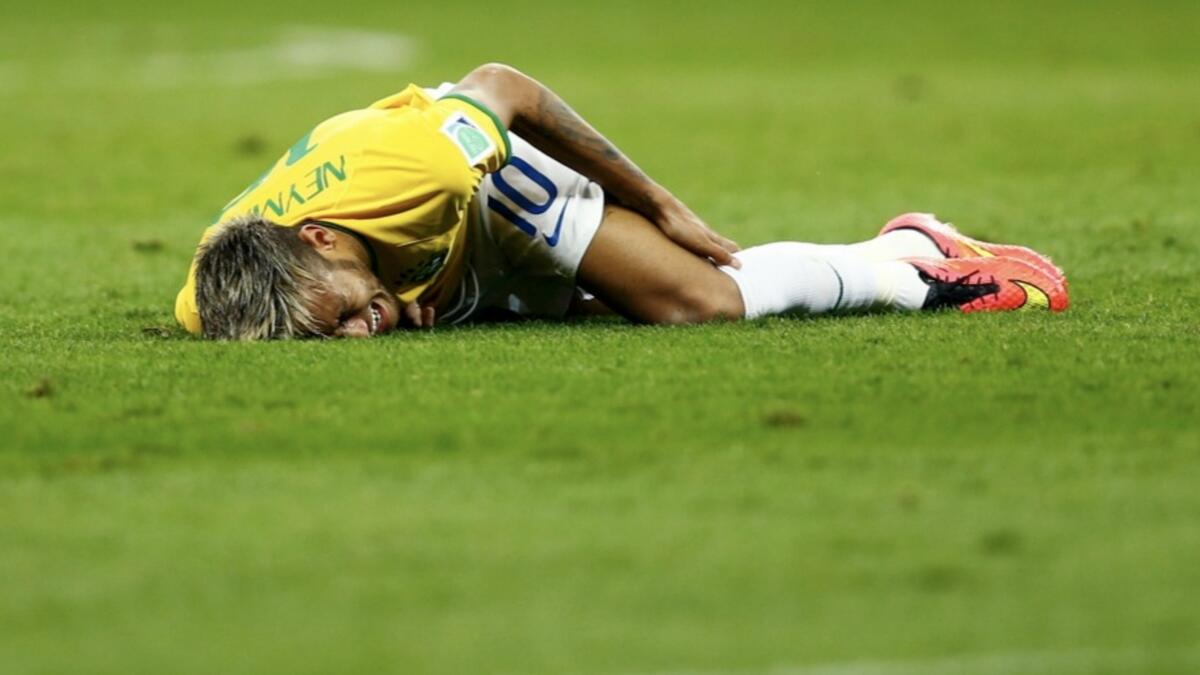 Brazil's Neymar lies on the pitch in pain after a tackle during the 2014 World Cup. Reuters