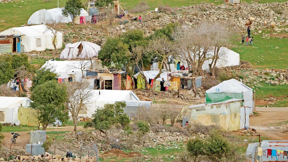Syrian villagers next to their tents near the village of Beerjam, on the Syrian side of the Golan Heights, seen from the Israeli-controlled Golan Heights. Children and families who are allowed into Israel as part of its ‘Good Neighbours’ programme mainly 