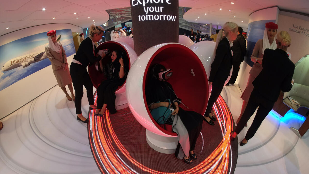 Visitors enjoy the virtual tour at Emirates Pavilion during Arabian Travel Market at DWTC Dubai on April 25, 2016.
