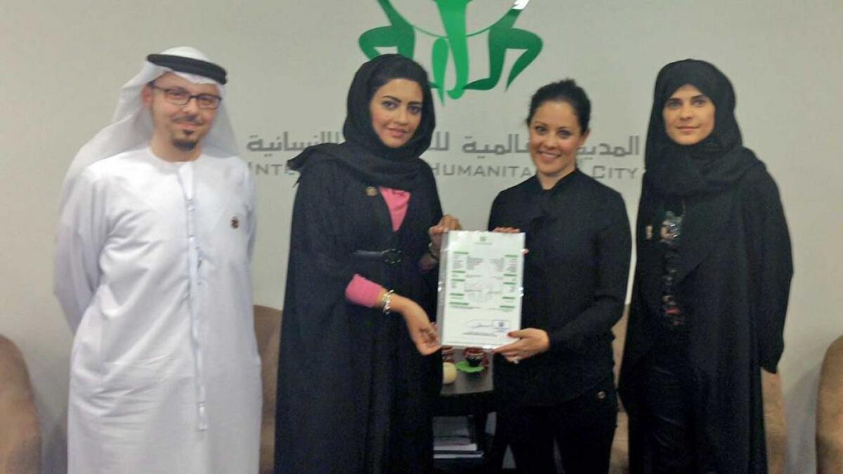 Maya Lahham with International Humanitarian City (IHC) officials in 2010, when CARE was given a membership to the IHC.