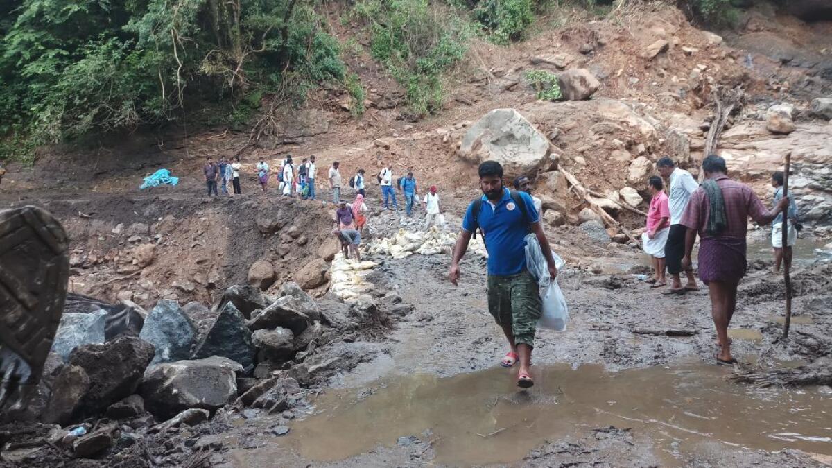 With landslides and a bridge washed away in flood, Avitis medical team walks the 30-km distance from Nemmara to hill station of Nelliyampathy.